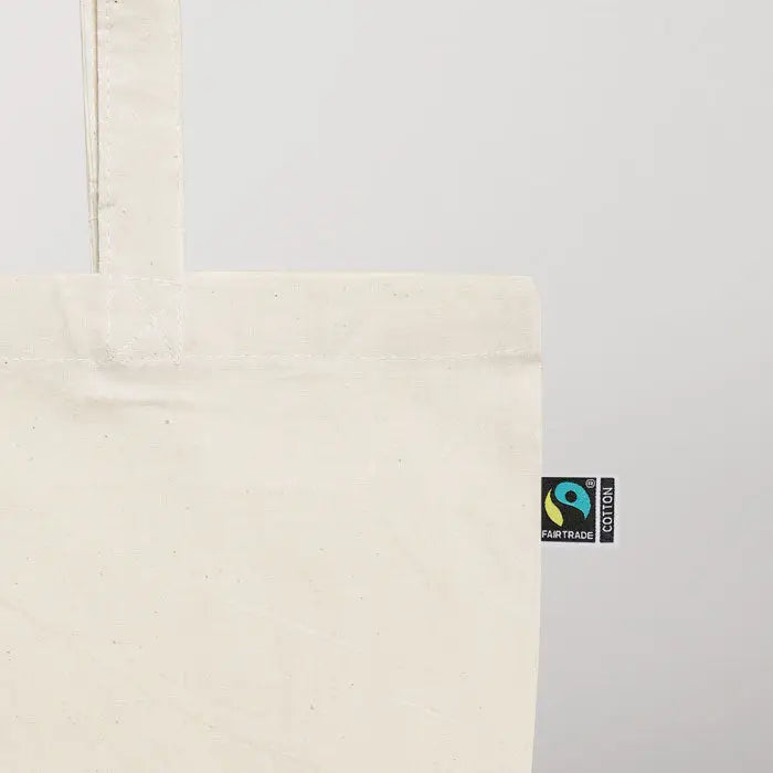 Off-white geanta de cumparaturi din bumbac fairtrade cu eticheta de comert echitabil in colt
