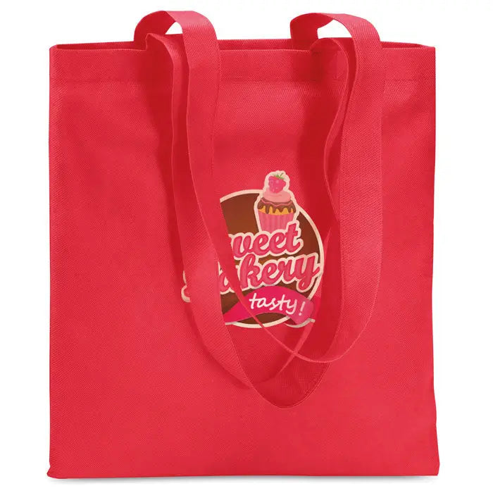 Geanta de cumparaturi netesuta de 80 gr/m² rosie cu manere asortate si logo sweet bakery cu design cupcake