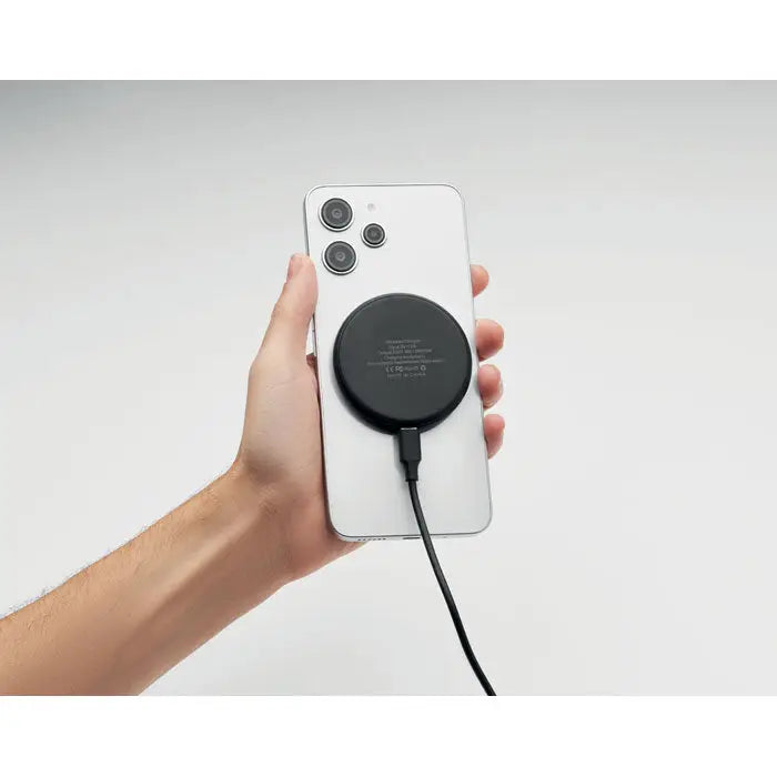 Încărcător wireless 3 în 1 negru rotund de 15w atașat pe spatele unui smartphone alb