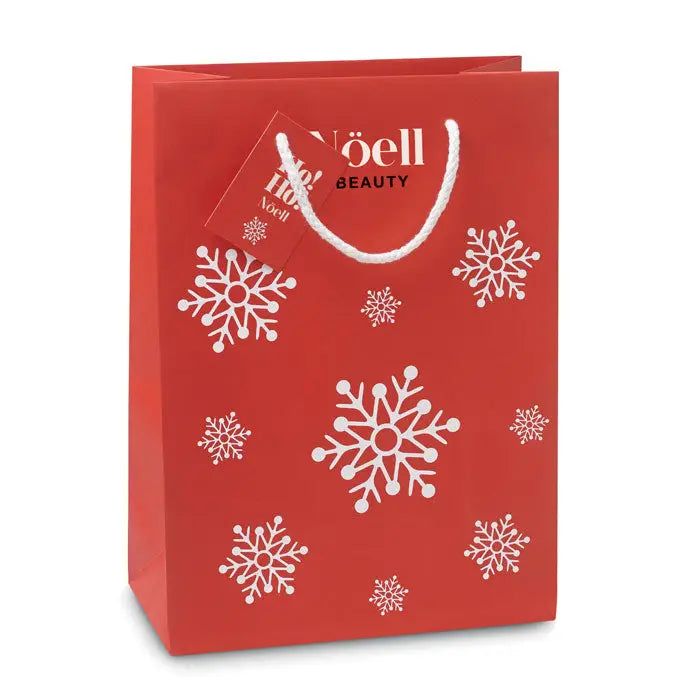 Punga de hartie cadou medie rosie cu modele de fulgi de nea albi si manere rasucite albe cu logo noëll beauty