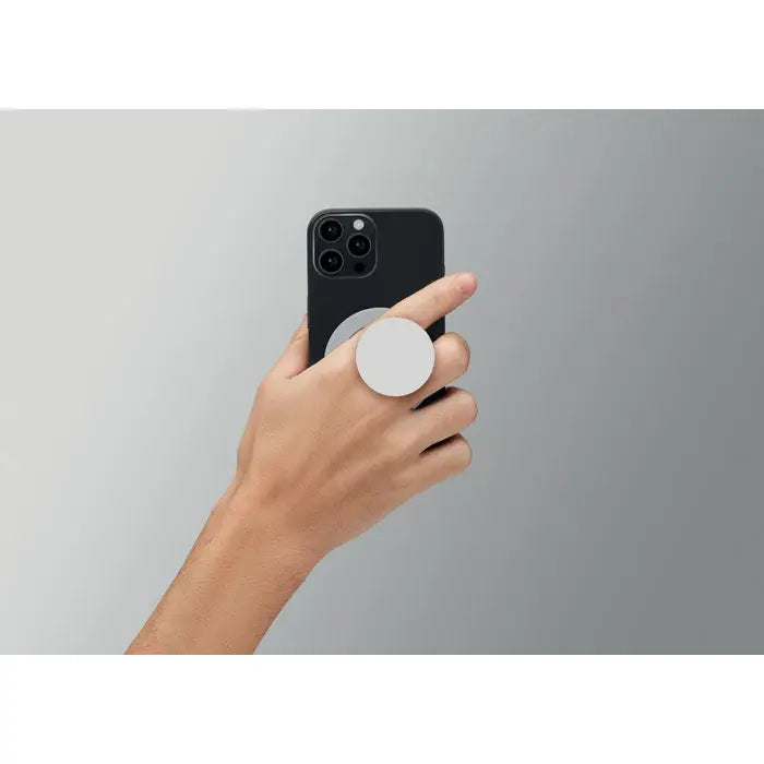 Suport magnetic pentru telefon alb circular atașat pe partea din spate a unui smartphone negru