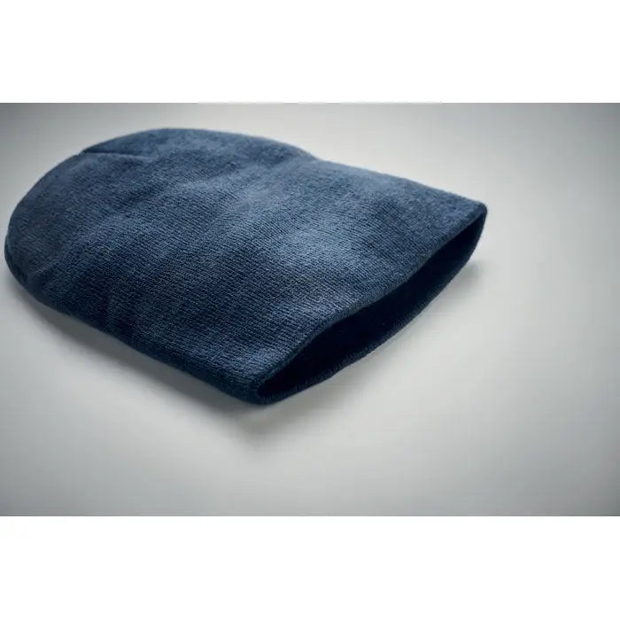 Bonita din poliester rpet este o caciula bleumarin din tricot moale cu margine pliata si textura fina