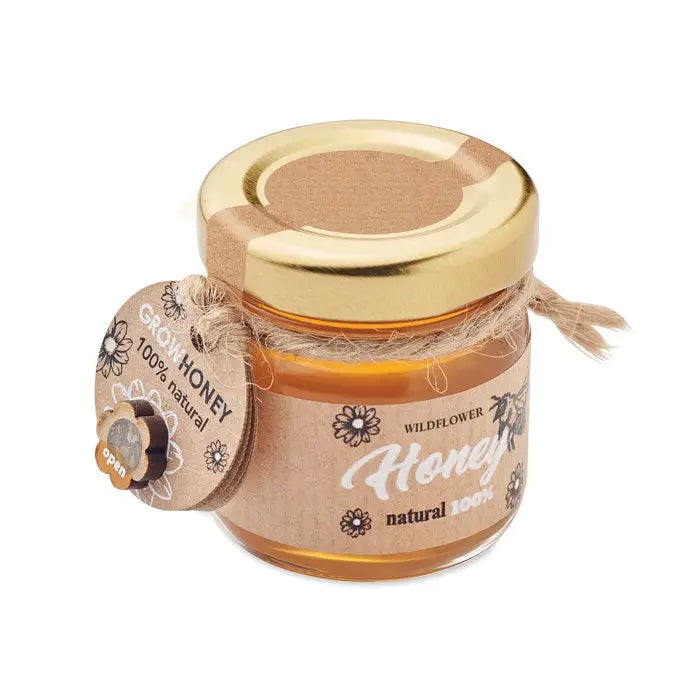 Borcan cu miere de flori salbatice 50 gr intr-un recipient mic de sticla cu capac auriu si eticheta rustica din hartie maro