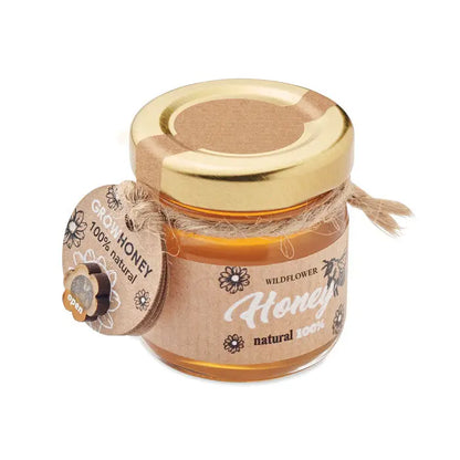 Borcan cu miere de flori salbatice 50 gr intr-un recipient mic de sticla cu capac auriu si eticheta rustica din hartie maro