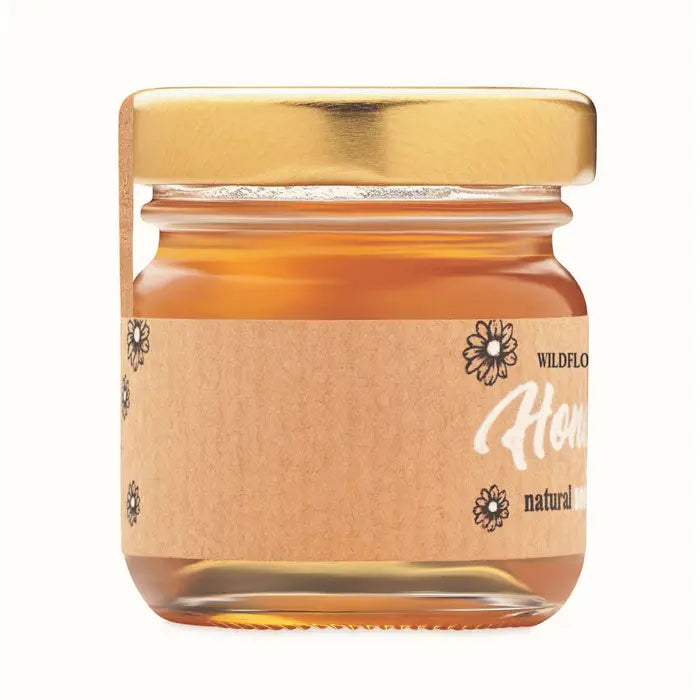 Borcan cu miere de flori salbatice 50 gr in sticla mica cu capac auriu si eticheta maro cu design floral negru