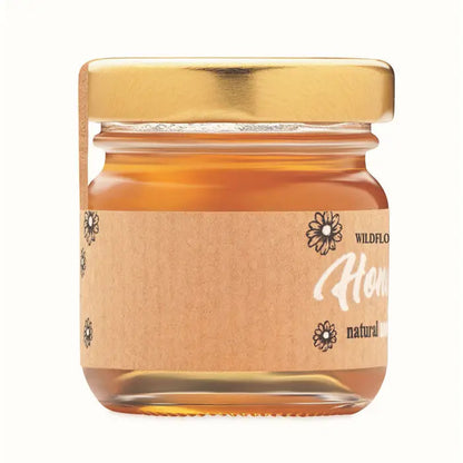 Borcan cu miere de flori salbatice 50 gr in sticla mica cu capac auriu si eticheta maro cu design floral negru