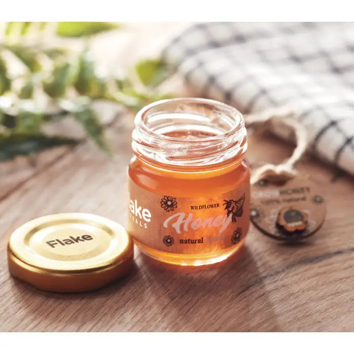 Borcan cu miere de flori salbatice 50 gr in recipient de sticla cu capac auriu si eticheta clara cu flori si natural
