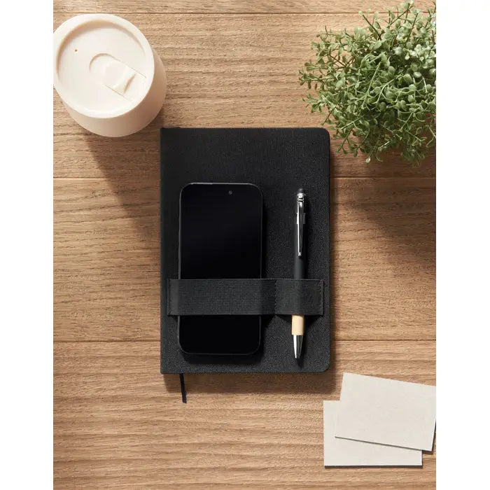 Caiet a5 rpet negru cu coperta texturata si elastic care tine un telefon si un pix