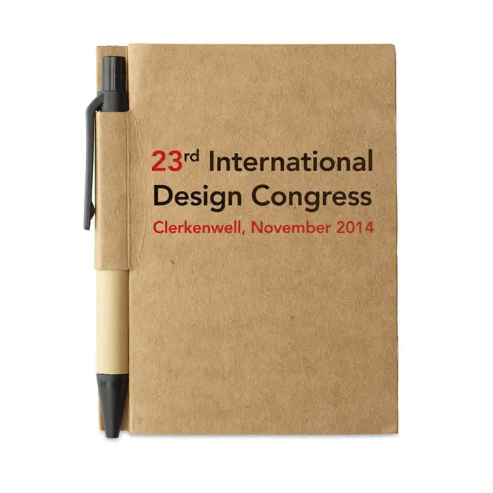 Caiet reciclat maro din hartie kraft cu pix negru si bej atasat si text 23rd international design congress ros si negru