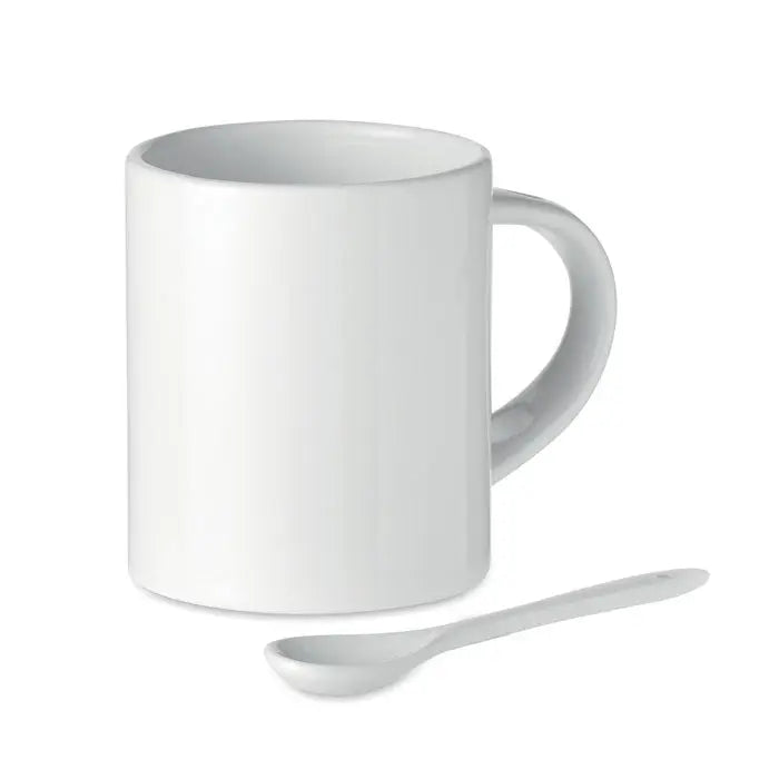 Cană ceramică sublimabilă albă de 300 ml cu finisaj lucios și linguriță albă asortată lângă ea