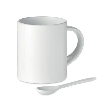 Cană ceramică sublimabilă albă de 300 ml cu finisaj lucios și linguriță albă asortată lângă ea