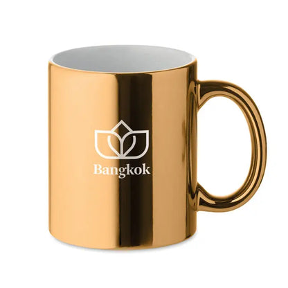 Cana din ceramica metalica 300 ml aurie lucioasa cu logo alb si inscriptia bangkok sub logo