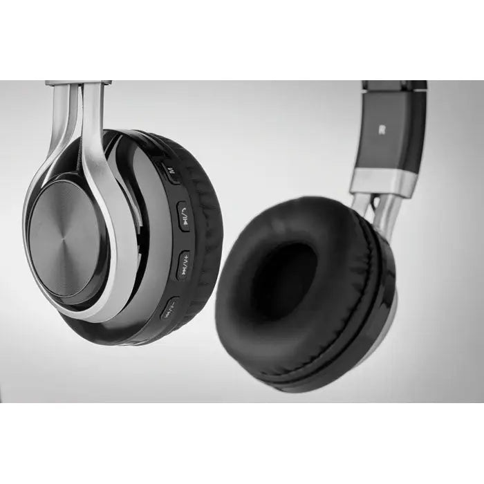 Casti fara fir negre si argintii peste ureche cu design modern si butoane texturate pentru control usor