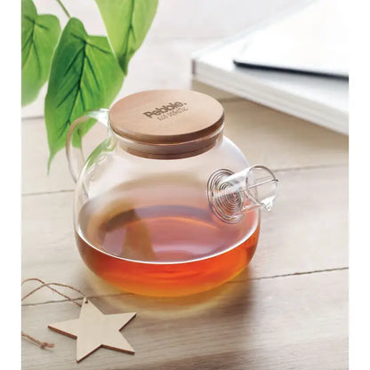 Ceainic din sticla borosilicata de 850ml cu capac de lemn pebble plin cu ceai de culoare chihlimbar