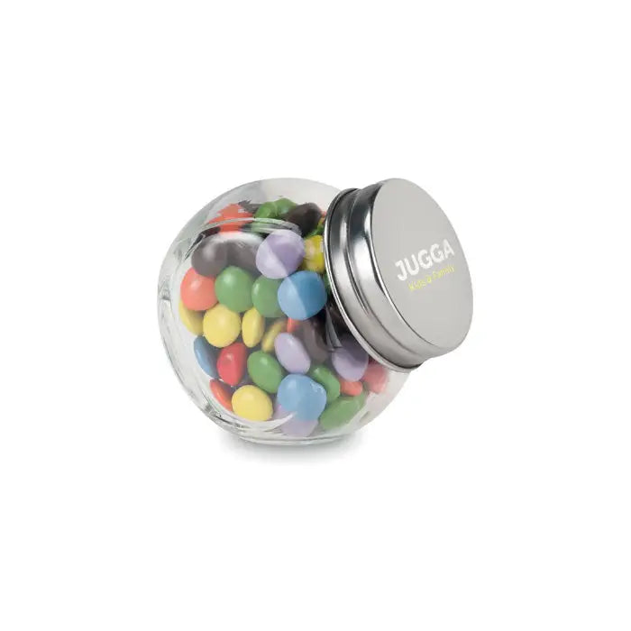 Ciocolata în suport de sticlă este un borcan transparent cu capac metalic argintiu plin cu bomboane colorate rotunde