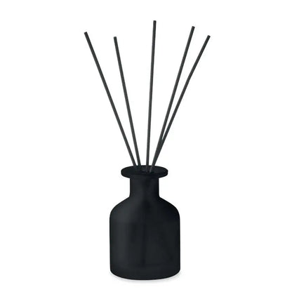 Difuzor de trestie de parfum de casa negru mat cu sase bete subtiri din lemn într-un vas rotund