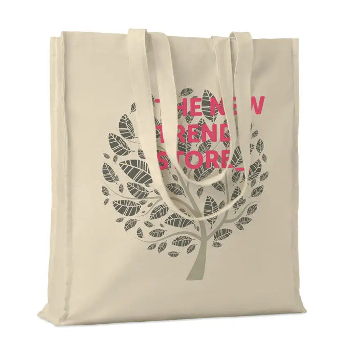 Geanta de cumparaturi din bumbac beige cu design copac frunze gri si text roz the new trend store