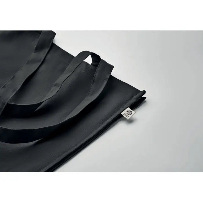 Geanta de cumparaturi din bumbac organic neagra cu manere rezistente si eticheta mica alba de brand