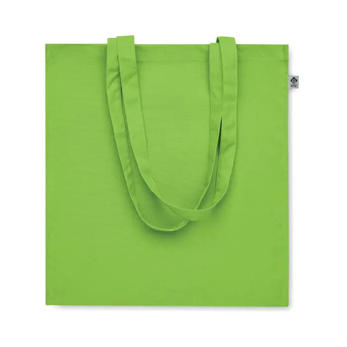 Geanta de cumparaturi din bumbac organic verde lime cu manere asortate si eticheta mica pe colt