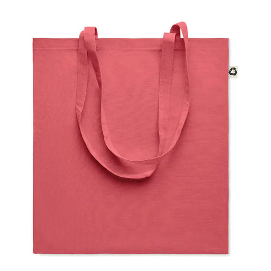 Geanta de cumparaturi din bumbac reciclat coral cu manere din material textil si eticheta mica pe colt