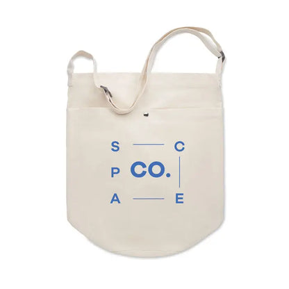 Cream-colored canvas tote bag with 270 gr/m² fabric and blue space co logo printed in minimalist font