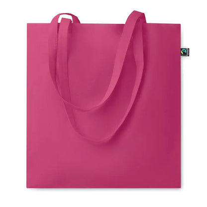 Geanta de cumparaturi fairtrade 140gr/m² din panza fucsia vibranta cu manere din acelasi material si eticheta verde de comert echitabil