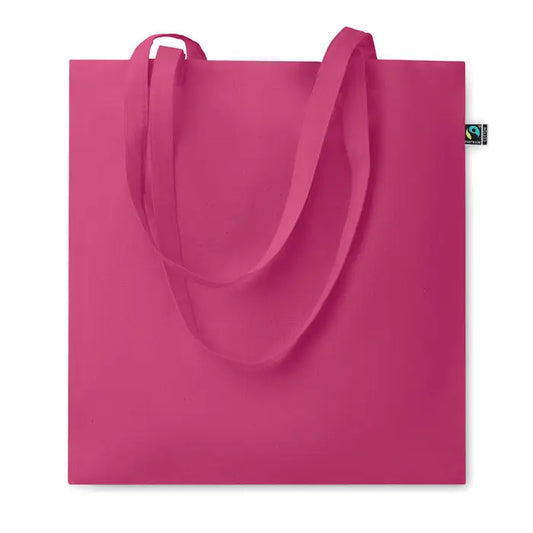 Geanta de cumparaturi fairtrade 140gr/m² din panza fucsia vibranta cu manere din acelasi material si eticheta verde de comert echitabil