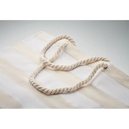 Cream-colored rope handles with twisted texture on striped cotton beach tote bag 220 gr/m²