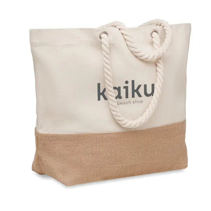 Geanta de plaja din panza bej cu manere din sfoara si fund din iuta cu logo kaiku beach shop