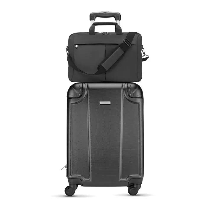 Geanta laptop in 2 tonuri 360d cu suprafata texturata si geanta laptop neagra asezata pe valiza rulanta neagra
