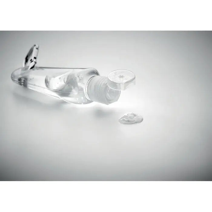 Gel de curatare maini 30 ml sticla transparenta din plastic cu capac alb si picatura mica de gel langa ea