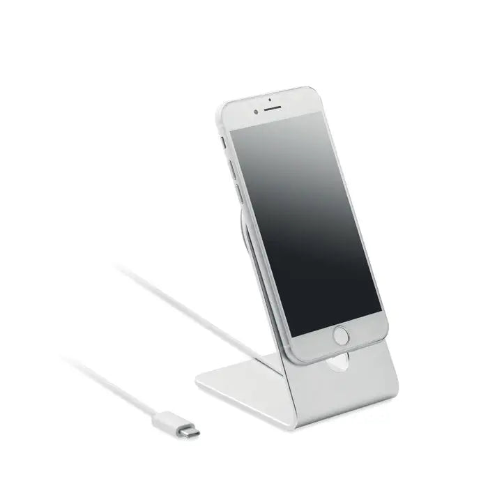 Stand telefón mobil portabil argintiu din metal cu design minimalist ținând un iPhone pentru încărcare magnetică 15W