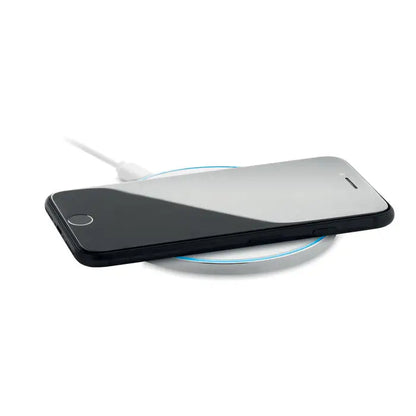 Incarcator wireless de sticla de 10w cu iphone negru si argintiu pe pad incarcare circular cu inel albastru luminos