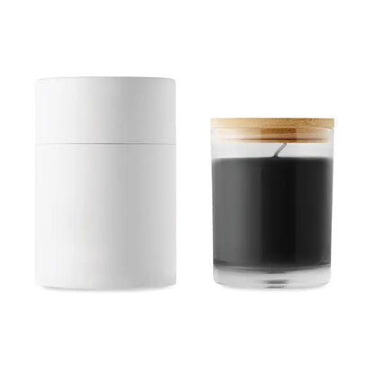 White cylindrical container next to a clear glass jar with wooden lid containing black candle wax for vanilla scented candle