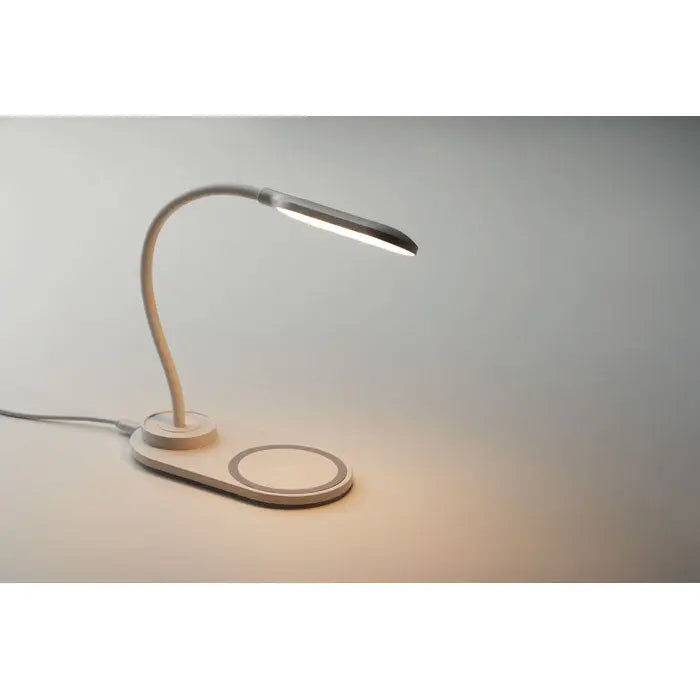 Beige modern desk lamp with flexible gooseneck and integrated 10w wireless charging pad for office use