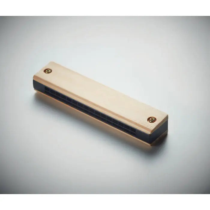 Muzicu?a light-colored wooden harmonica with black grille and brass screws for music playing