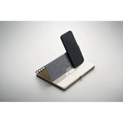 Notebook a5 cu suport pentru telefon cu telefon negru pe suport gri texturat cu pagini crem spirala spiralatã