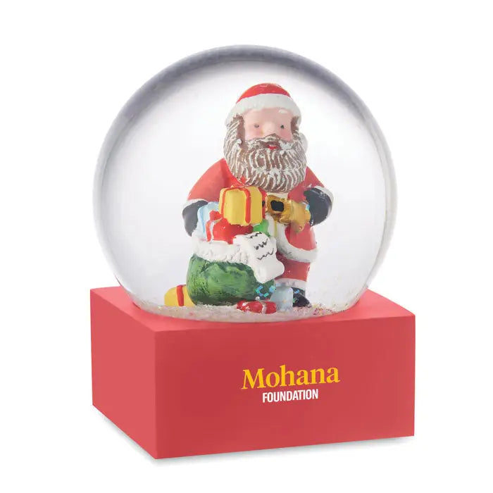Ornament de sticla cu bile de zapada cu suport dreptunghiular rosu si text mohana foundation galben si alb si glob de zapada cu mos craciun