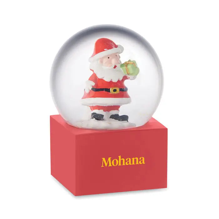 Ornament mic din sticla cu bile de zapada cu glob transparent ce ilustreaza mos craciun rosu cu cadou verde pe baza rosie cu branding mohana auriu