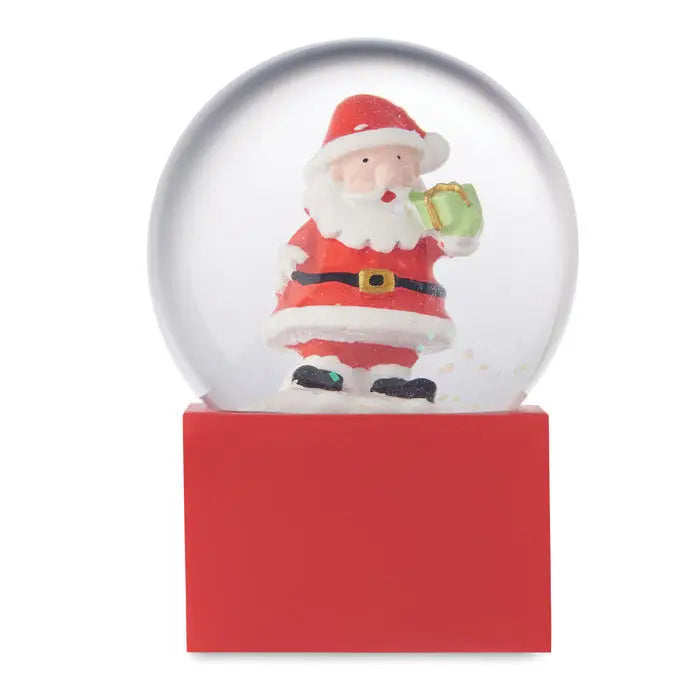 Ornament mic din sticla cu bile de zapada cu baza rosie si figurina mos craciun in halat alb si rosu care tine o cana verde