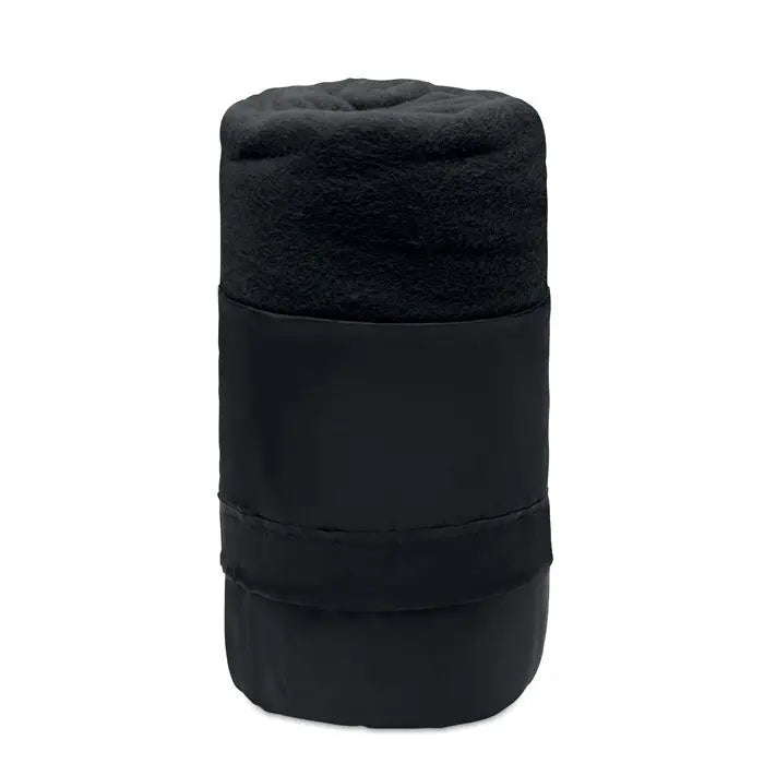 Pătură de călătorie din lână rpet neagră rulată și prinsă cu benzi din material textil negru