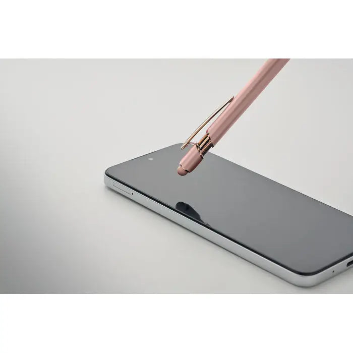 Pix din aluminiu reciclat stilou rose gold cu finisaj metalic si varf retractabil deasupra ecranului unui smartphone