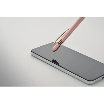 Pix din aluminiu reciclat stilou rose gold cu finisaj metalic si varf retractabil deasupra ecranului unui smartphone