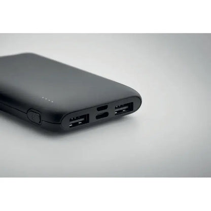 Power bank 5000 mah negru dreptunghiular cu multiple porturi usb și buton circular pe lateral