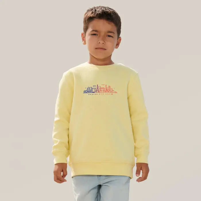 Pulover columbia kids galben pal cu mâneci lungi și grafică colorată a orizontului orașului pe piept