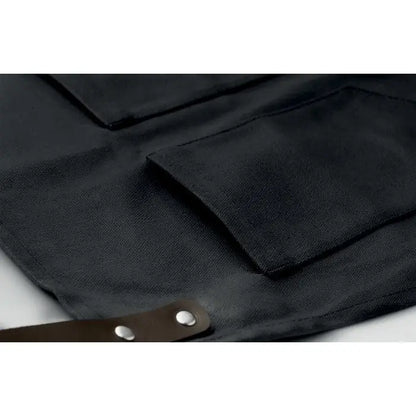 Sort din piele black canvas apron cu barete maro din piele si nituri argintii pentru protectie si durabilitate