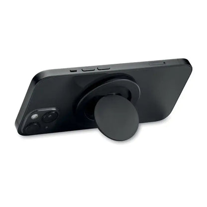 Suport magnetic pentru telefon negru din silicon montat pe spatele unui smartphone pentru prindere usoara