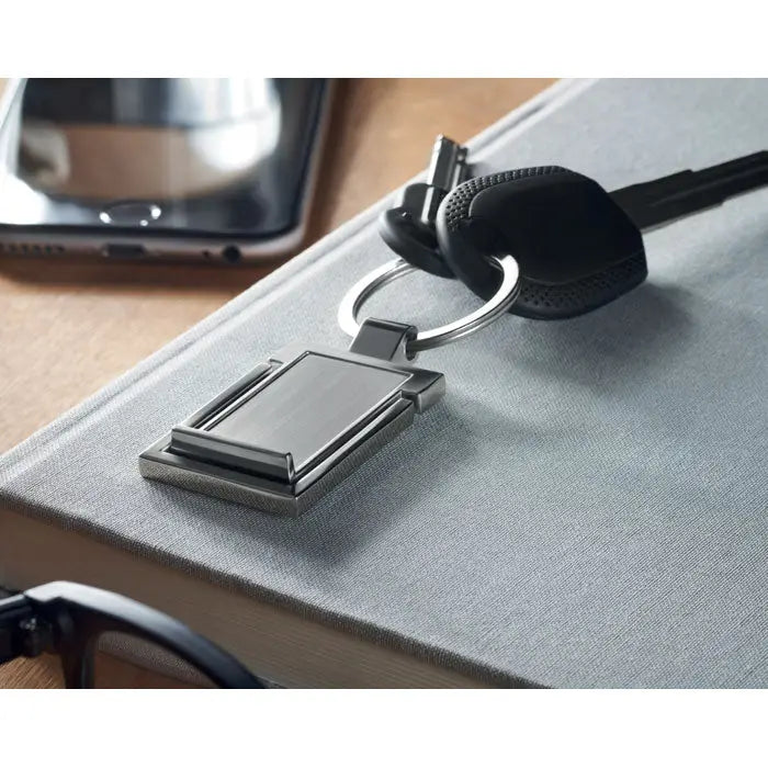 Suport metalic pentru telefon cu inel pentru chei argintiu dreptunghiular cu design modern si finisaj metalic mat