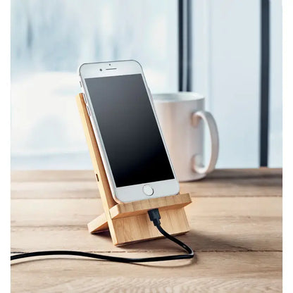Suport pentru incarcator wireless 10W din bambus cu iphone alb incarcand pe un suport minimalist