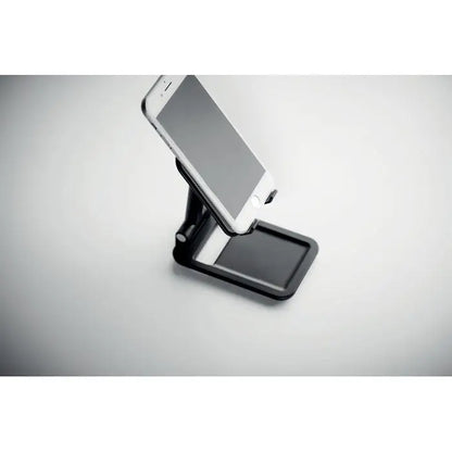 Suport pentru smartphone pliabil negru ajustabil din metal tinand un telefon alb